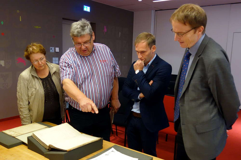 Dr. Ralf Lusiardi (v.r.), stellvertretender Leiter des Landesarchivs, Dr. Björn Schmalz, Dr. Gerhard Schulz und Maria Schulz sichten die Gründungsurkunde. 